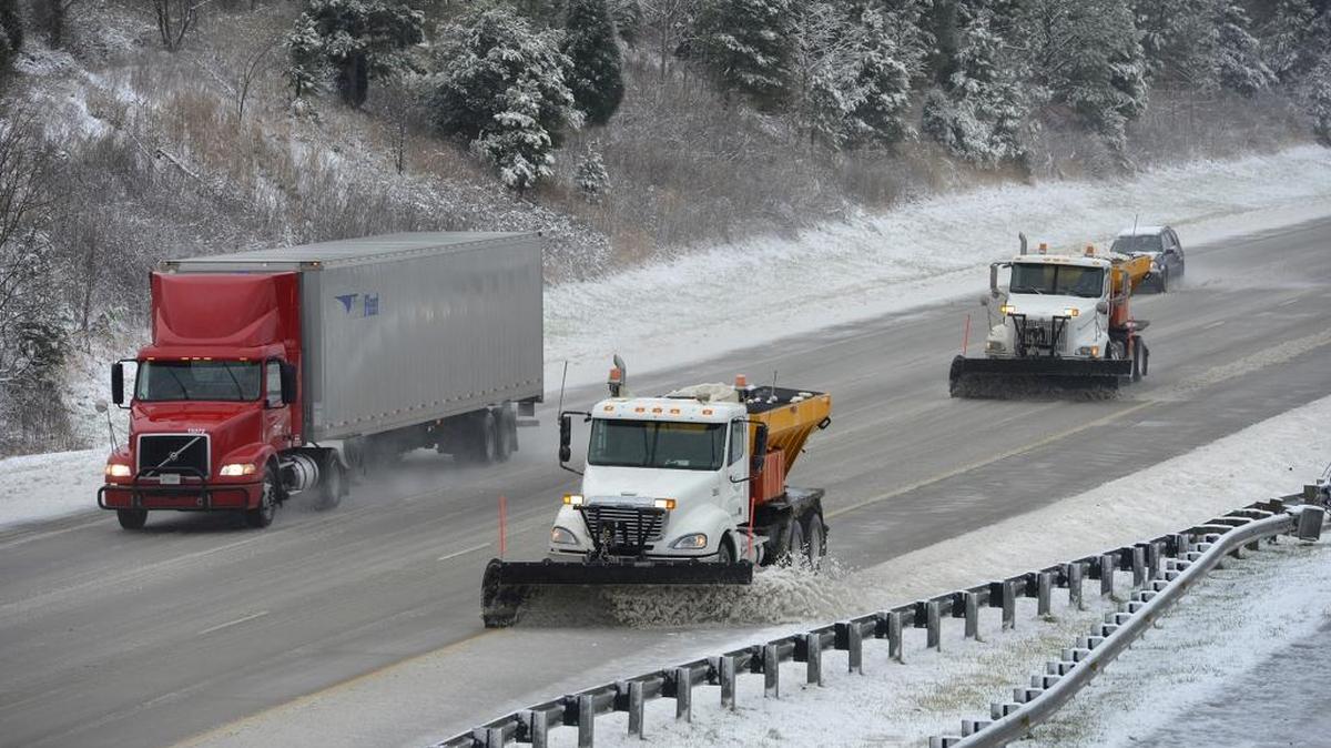 Snow plows at work on Interstate 485 near West Boulevard on Friday afternoon.