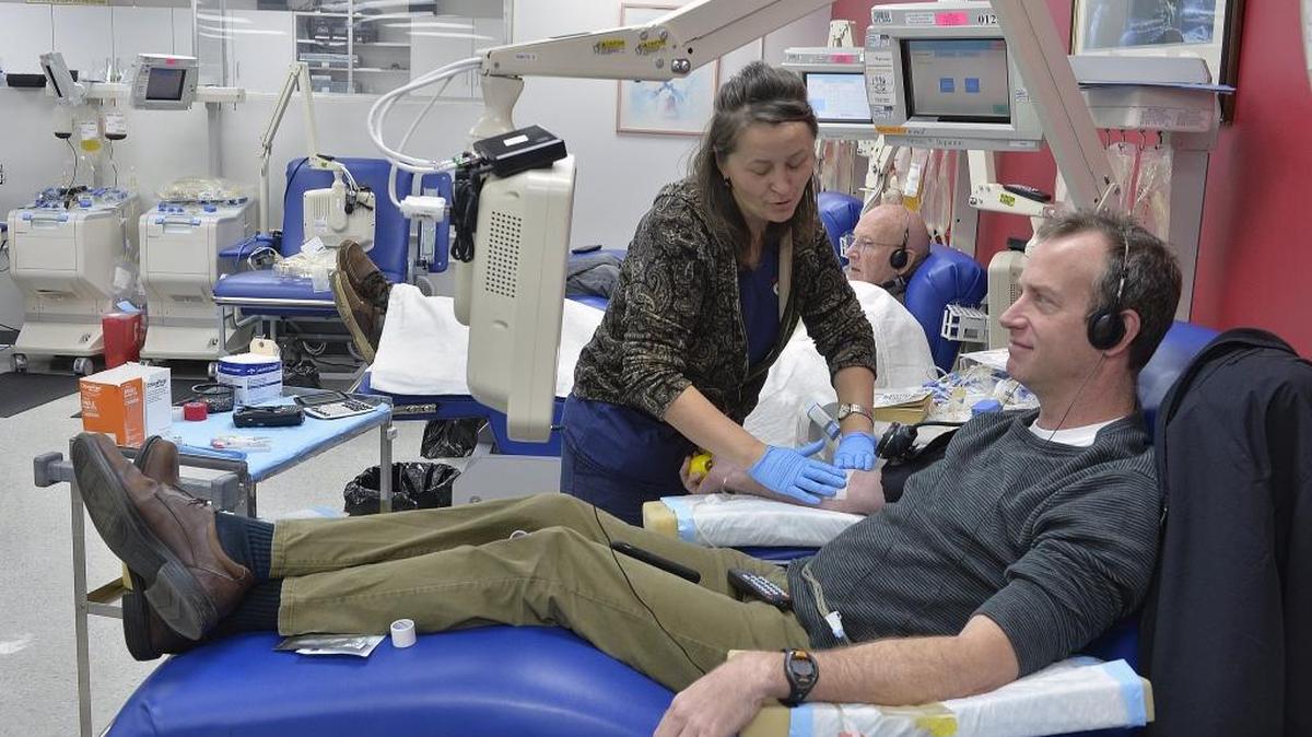 Blood collection specialist Elaine Burt at the American Red Cross office in Dilworth prepares a blood platelet donor.
