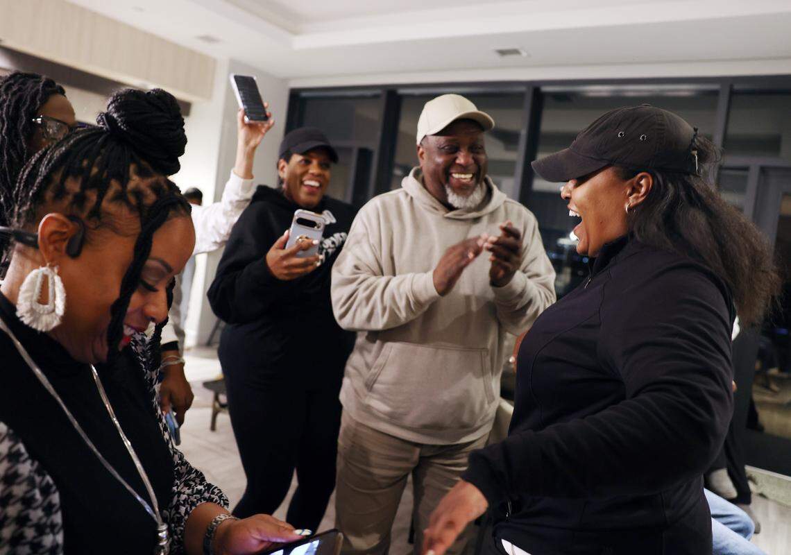 Monifa Drayton, right, who defeated long-time incumbent Vilma Leake in the District 2 Democratic primary for the Mecklenburg Board of County Commissioners Tuesday, March 3, 2036 cheers with friends and family at the Hyatt Centric in Charlotte.