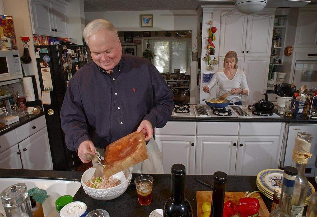In this 2004 file photo, Pat Conroy and his wife Cassandra King Conroy were in the kitchen promoting a cookbook Pat Conroy wrote. In her new memoir, “Tell Me a Story,” Cassandra King Conroy shares what it was like living with her late husband.