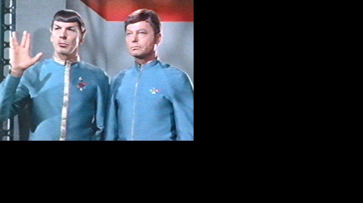 
Screen grab of Mr. Spock, actor Leonard Nimoy, left, giving the Vulcan salute on an episode of 1967 Star Trek entitled "Journey to Babel". Credit Paramount Television. Dr. McCoy, actor DeForrest Kelley, stands to the right.
