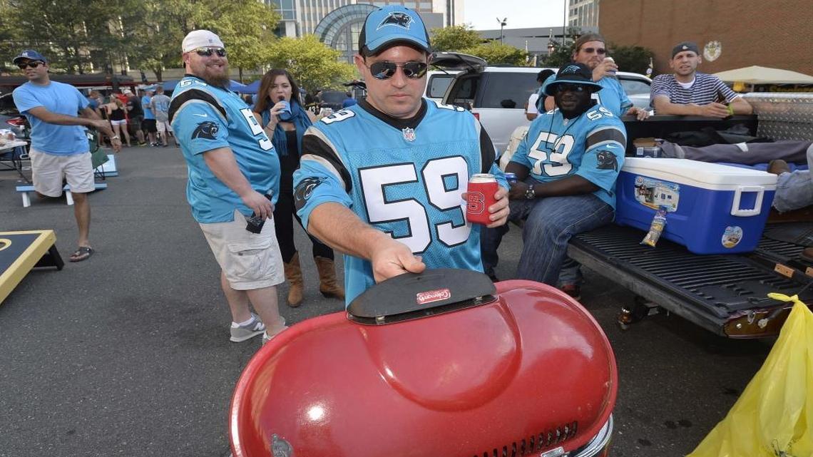 Carolina Panthers fan Miles Moore of Raleigh prepares to grill burgers while tailgating in uptown for last season’s game against Houston.