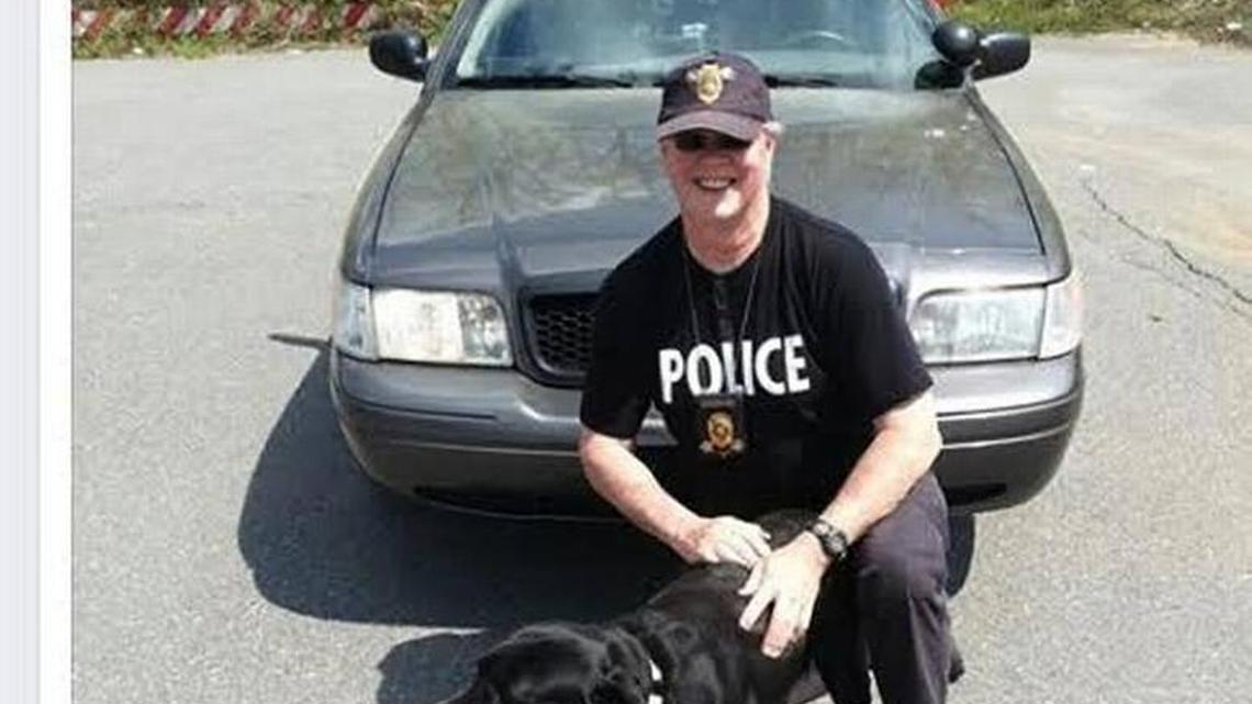 Walter Scott, in his law enforcement apparel, with a dog from a picture posted on his Facebook page.