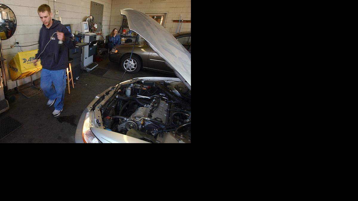 
An inspector in Charlotte prepares to test a car’s emissions with diagnostic equipment.
