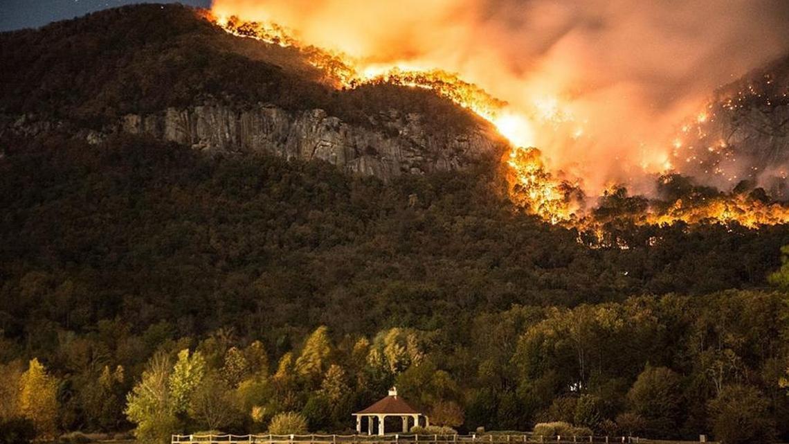 Wildfires rage above the waters of Lake Lure last November.