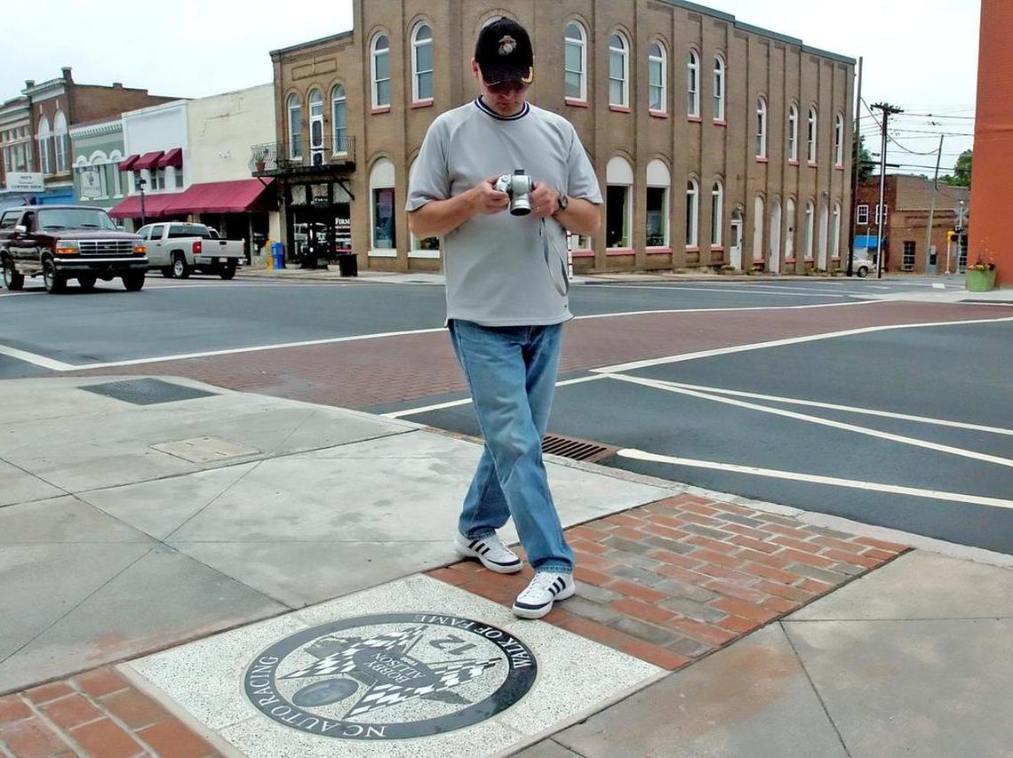The North Carolina Auto Racing Walk of Fame sidewalk contains images Hall of Fame NASCAR drivers. A Mooresville Motorsports Celebration is scheduled for Oct. 3, 2023.