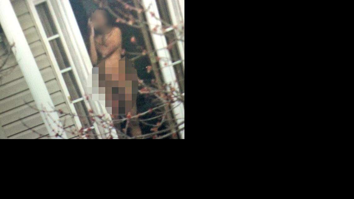 
Edited version of photo neighbors took of the man standing at his door Friday. 
