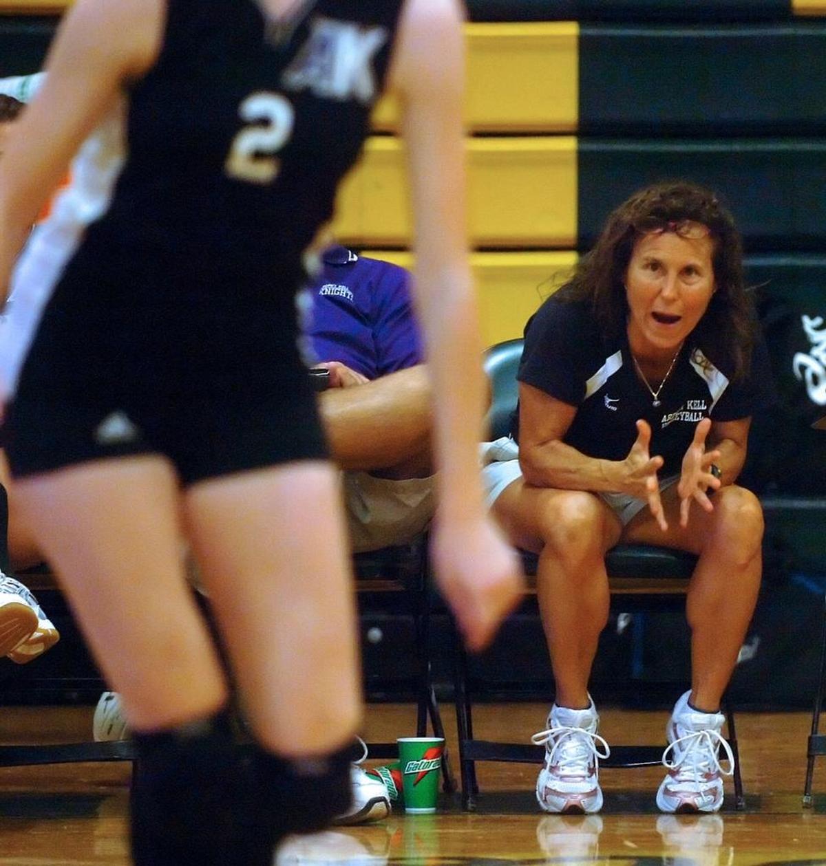 Zoe Bell, shown here exhorting a player, understands being cut from the team. She once was cut from the Appalachian State team.