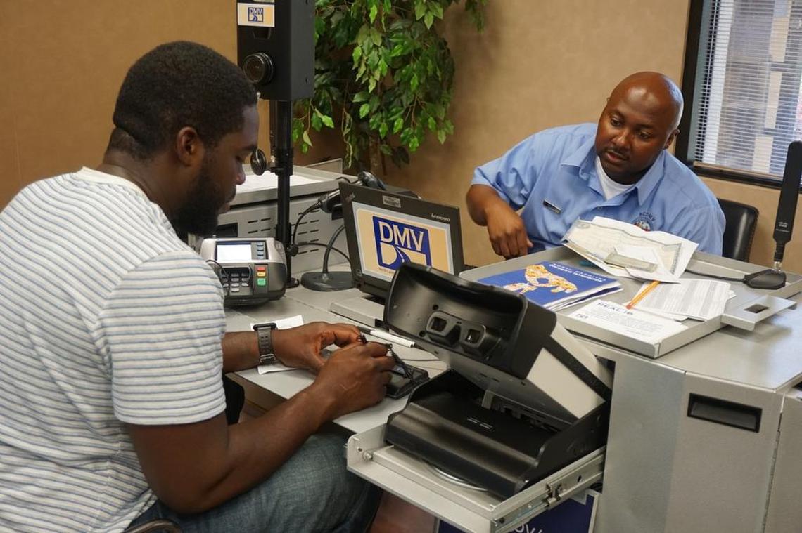 Charles Byrd, left, photographed in 2017 getting an instate license with the help of Ken Adams, NCDMV driver’s license examiner.