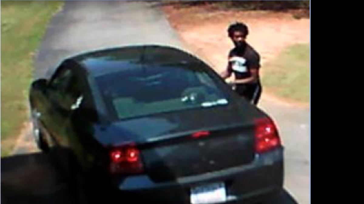 
The Gaston County Police Department is seeking the identity of the suspect of a residential burglary that occurred at approximately 1100am on May 5, 2015 at 1206 Killian Rd off Hwy 16 in the northeast portion of Gaston County. Surveillance video captured the suspect and his vehicle during the commission of the crime. The suspect is described as a black male wearing a black t-shirt and black shorts with red trim. He was also wearing red athletic shoes. There was another unidentified individual with the suspect and they were driving a dark blue or dark gray Dodge Charger. 
