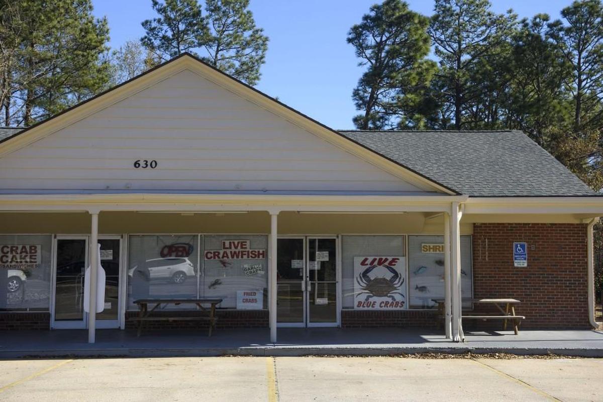 This Tuesday, Jan. 9, 2018 photo shows John C's Fish Market in Fayetteville, N.C. Authorities in North Carolina have charged several people after former members of a religious group complained that a minister was forcing children to work in his fish markets for little or no money.