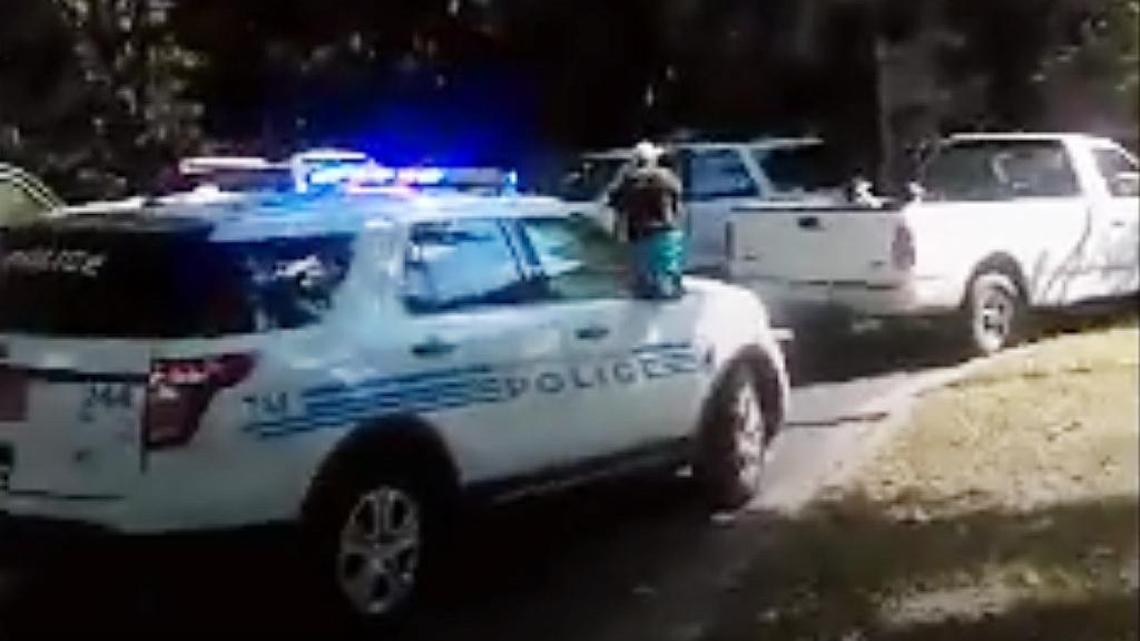 Keith Lamont Scott (center) is seen standing amid several vehicles – though it’s being reported nationally that he is not visible until after being shot.