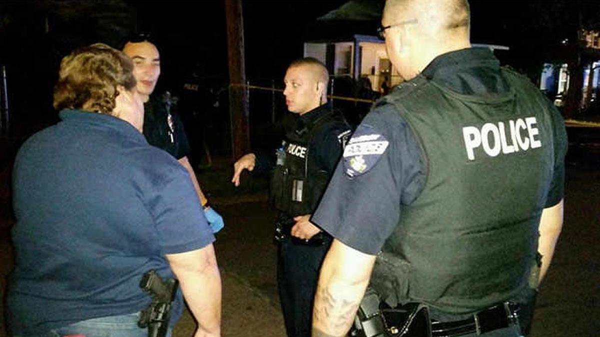 Police officers gather at the scene of the shooting in Salisbury on Wednesday night.
