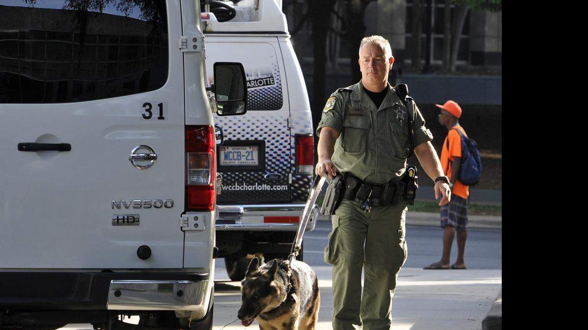 
A Mecklenburg County Sheriff deputy patrols the sidewalk around the Mecklenburg County Courthouse, Wednesday, July 22, 2015. Wednesday is the third day of CMPD officer Randall "Wes" Kerrick's trial for killing Jonathan Ferrell. Kerrick is charged with voluntary manslaughter in the shooting death of 24-year-old Jonathan Ferrell on September 14, 2013, along Reedy Creek Road. Ferrell was unarmed and shot ten times.
