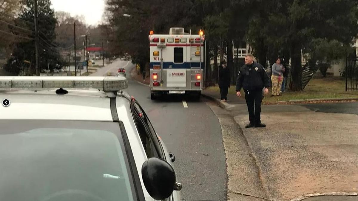 Authorities at the scene of a domestic-related multiple killings Saturday.