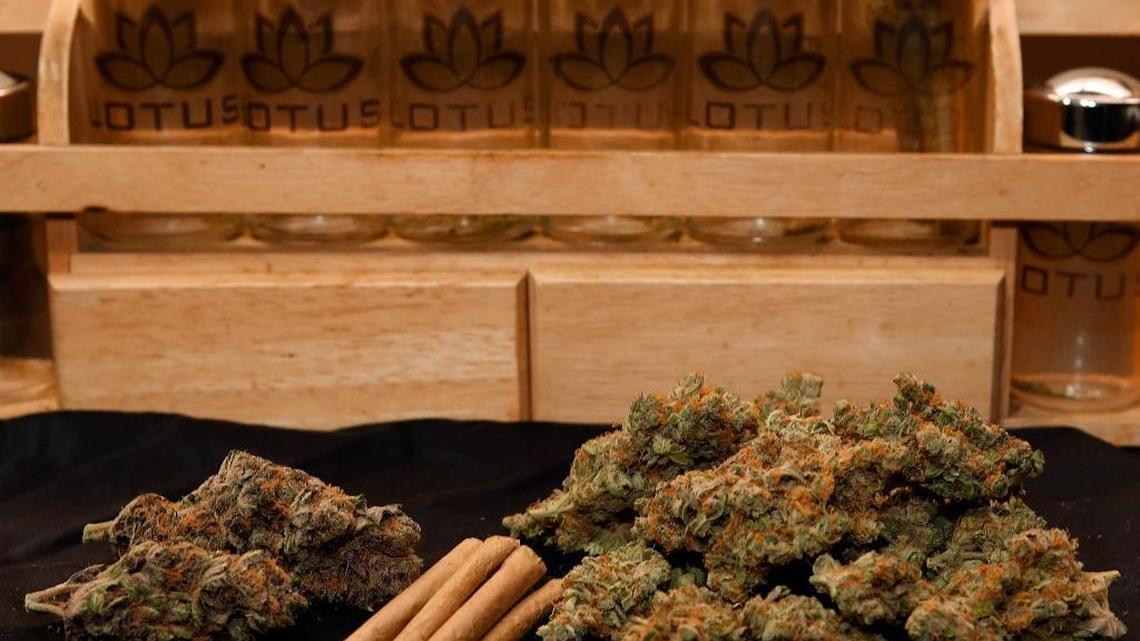 FILE - In this April 24, 2013, file photo, A 1/4 ounce, left, and one ounce of marijuana are displayed along with a handful of joints at a dispensary in Denver. An Observer review of CMPD arrest records, as well as more than 20,000 N.C. court records, shows that over the last two years, Charlotte police arrested blacks found with less than a half-ounce of marijuana at about three times the rate of whites, or 28 percent to 10 percent.