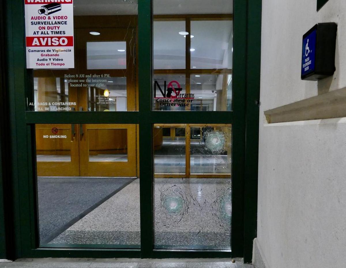 Bullet holes in glass outside the lobby of CMPD headquarters in uptown Charlotte.