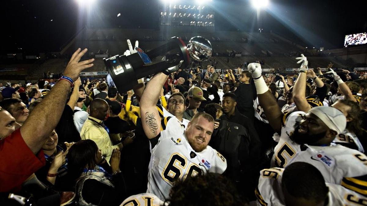 Appalachian State offensive lineman Jamie Collmar holds the Camellia Bowl trophy after winning 2016’s game in Montgomery, Ala. Police are asking for help in finding Camellia Bowl rings that were stolen in recent break-ins.