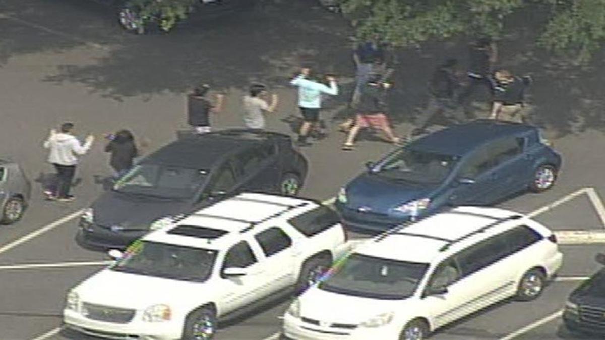 Newton-Conover High School students are seen being let out of school with their hands up after Wednesday’s lockdown was lifted.