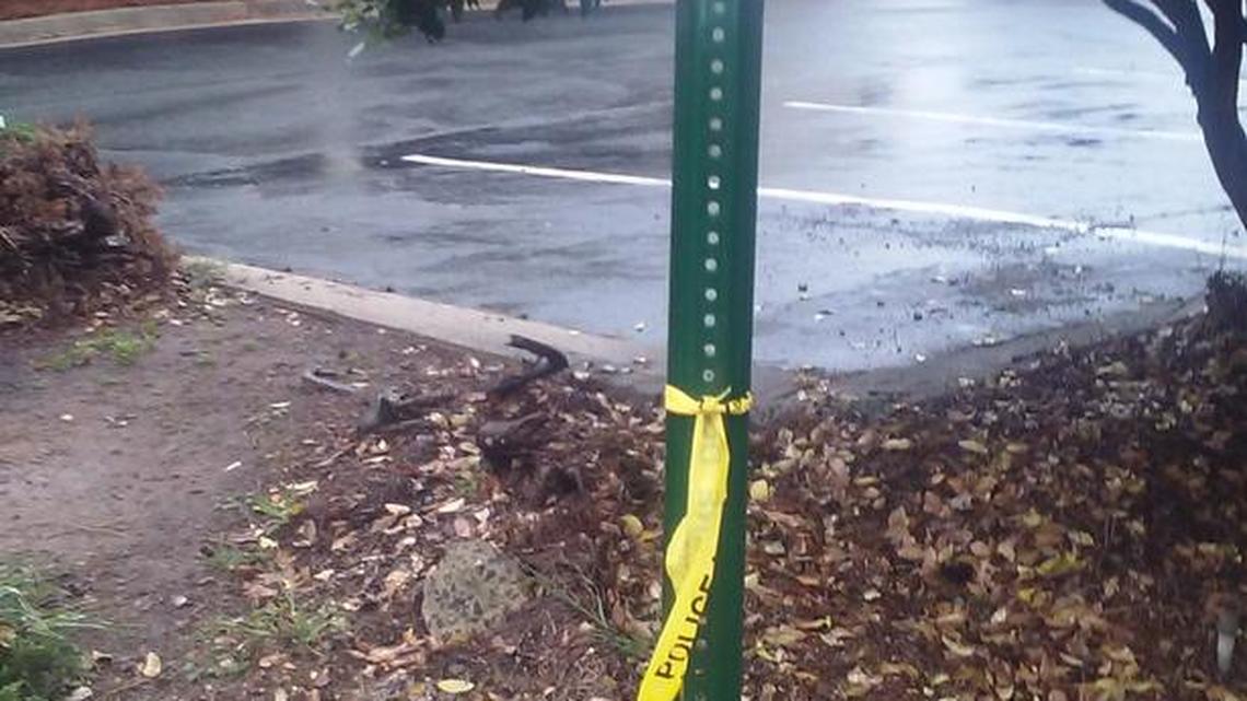 Crime scene tape hangs from a pole near Woodlawn Road where police say they discovered a dead body.