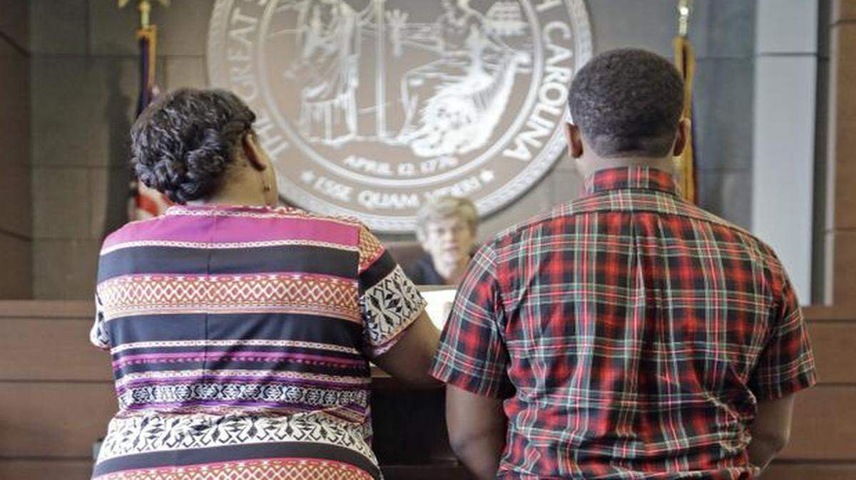
Public defender PhyliciaPower, left, and a young offender, right, stand before Durham County Senior District Court Judge Marcia Morey, center, as she presides over the misdemeanor diversion program for first-time teen offenders in a Durham County courtroom on April 10, 2015. 
