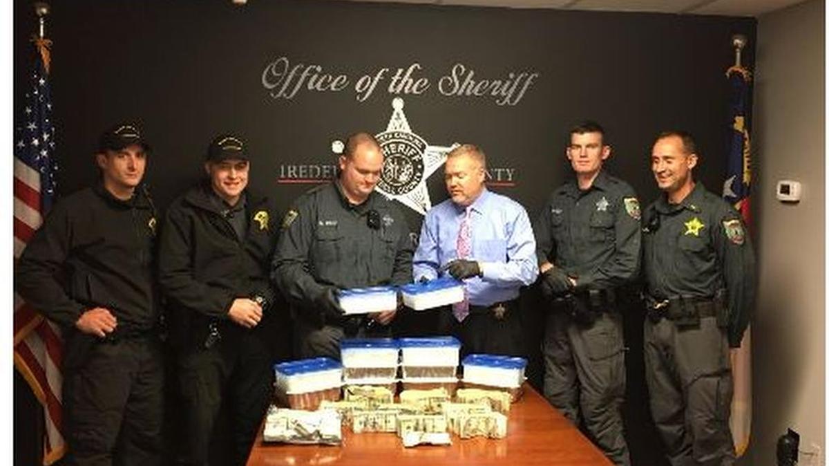 At a news conference on Wednesday, Iredell County Sheriff Darren Campbell (in dress shirt and tie) poses with officers who seized $5.2 million worth of methamphetamine and $100,000 in cash from four vehicles on Interstate 77 on Tuesday afternoon.