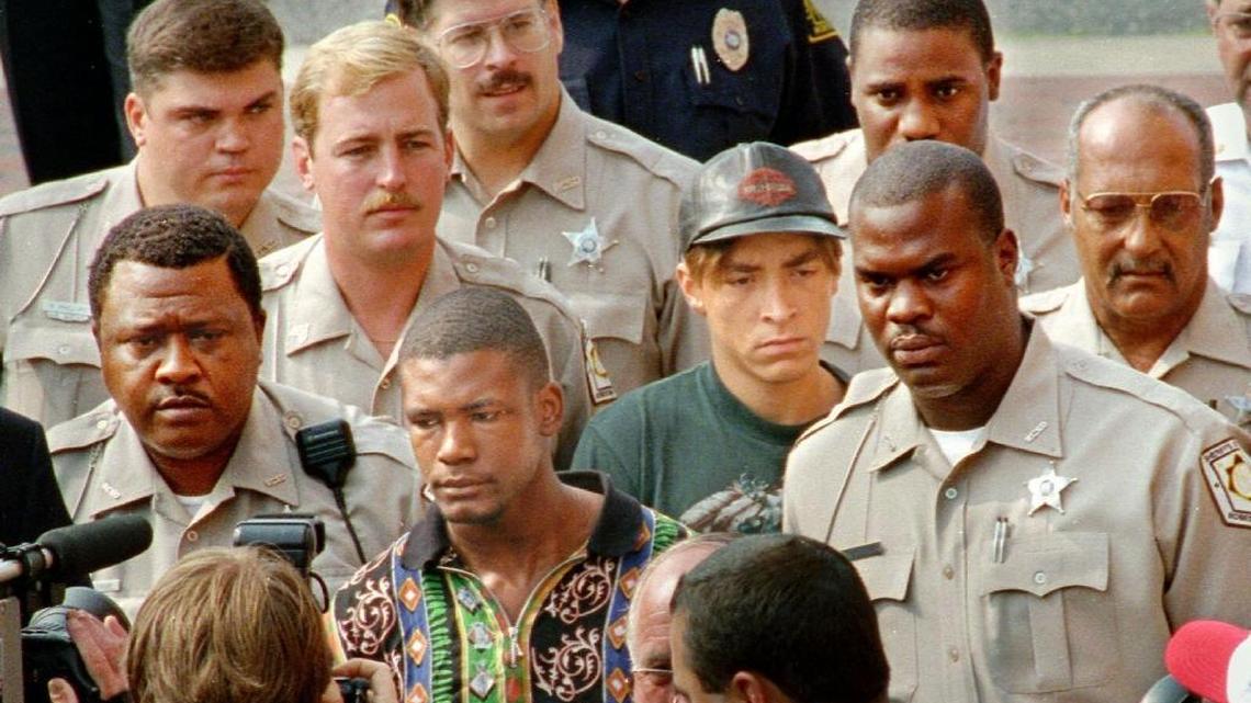 Surrounded by deputies, Daneil Green, foreground, and Larry Demery enter the Robeson County Courthouse in 1993 for arraignment in the slaying of James Jordan.