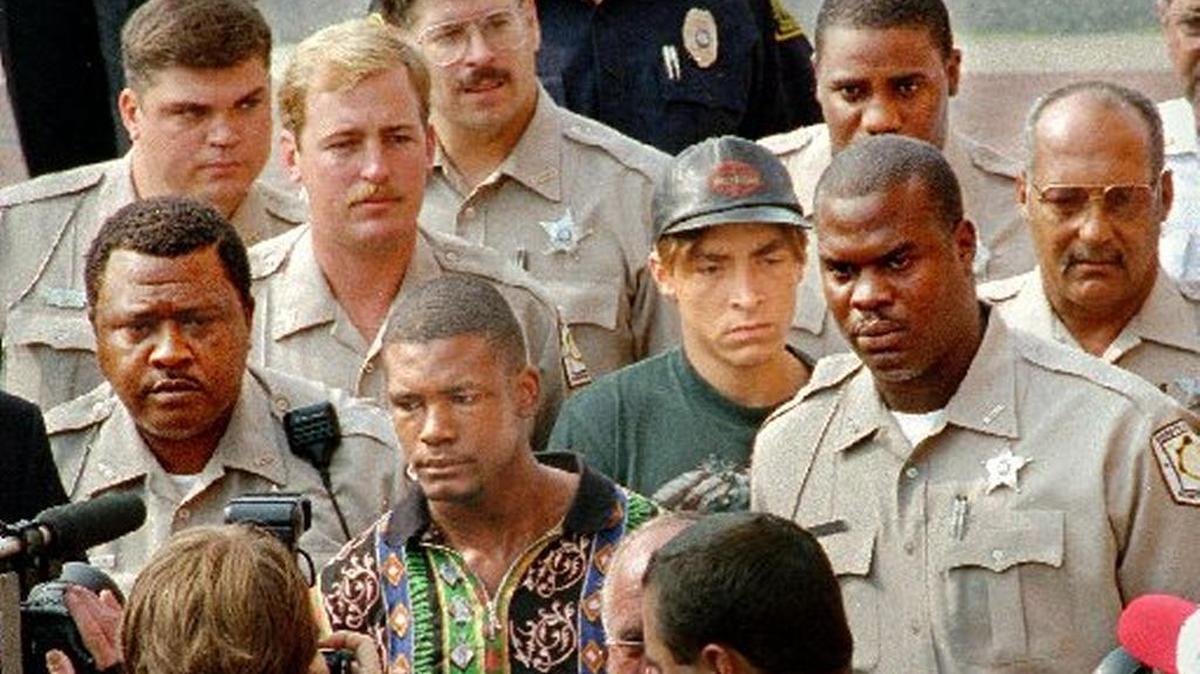 Daniel Green, left, and Larry Demery (center, right, in hat) are surrounded by Robeson County deputies after their 1993 arrests in connection with the murder of James Jordan. At trial, Demery said Green shot and killed Michael Jordan’s father during a robbery attempt. Green’s attorneys say he deserves a new trial.