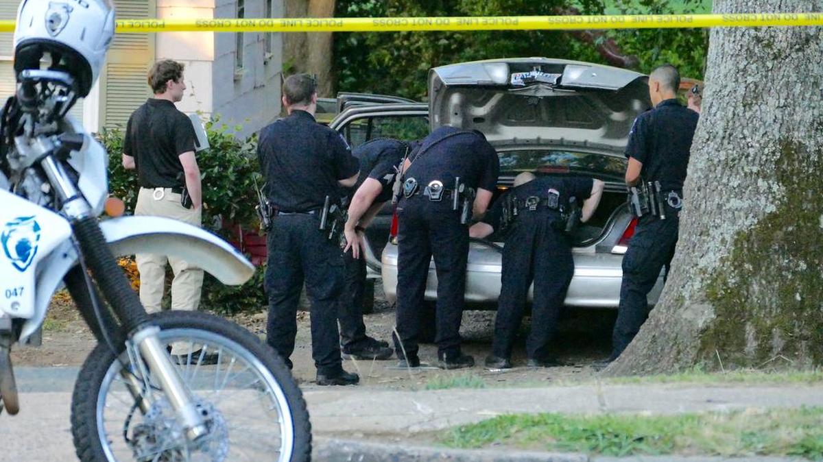 Charlotte-Mecklenburg police search a car and home on West Arrowood Road at Fawnbrook Lane Thursday morning. Dozens of bullets were fired into two homes near the intersection early Thursday. No injuries have been reported.