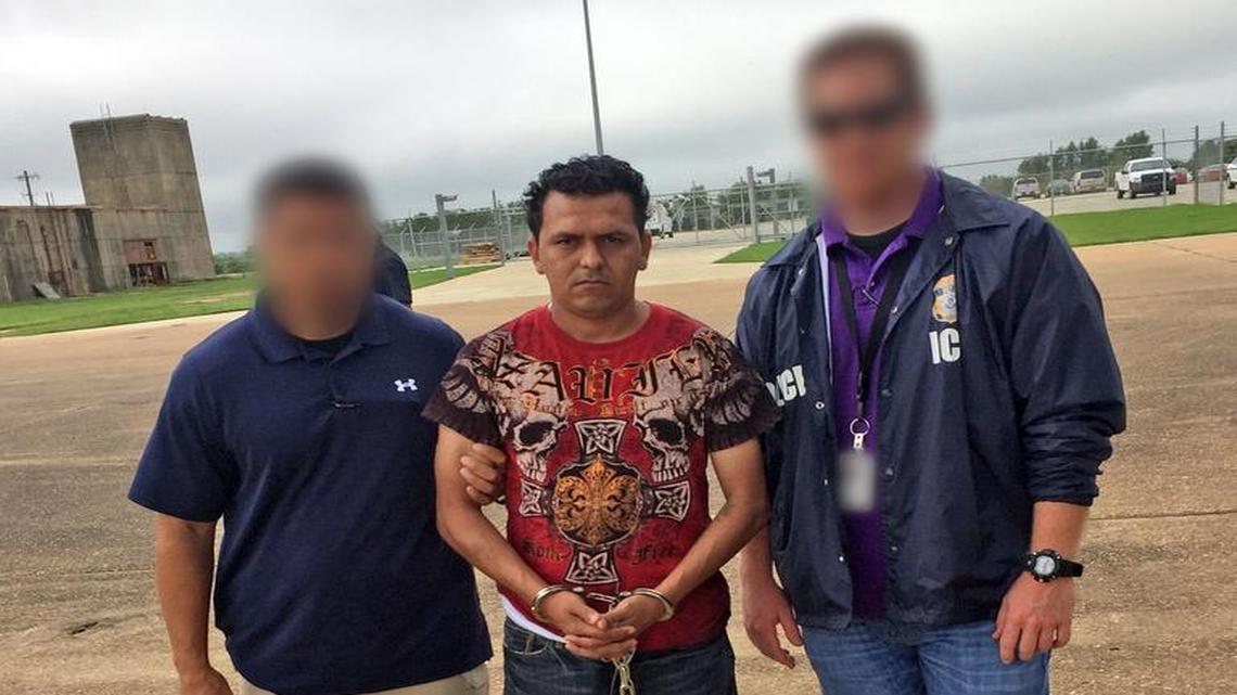 Salvadoran MS-13 gang member Melvin Ramos is shown with two ICE deportation officers Friday morning on the tarmac of Alexandria (La.) International Airport, before he boarded an ICE Air charter flight to San Salvador, El Salvador. U.S. Immigration and Customs Enforcement blurred the faces of the officers in the photo to protect their identities.