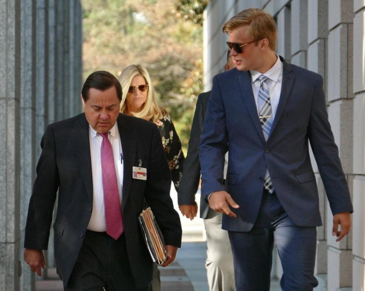 Former UNC Charlotte quarterback Kevin Olsen, shown with his attorney George Laughrun at a preliminary hearing, went on trial Monday facing three counts of second degree rape involving his former girlfriend.