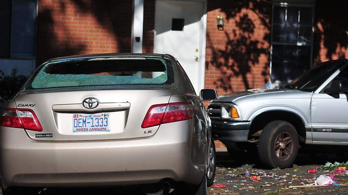 
A shattered car window and candy from a pi–ata are visible outside a home on Fieldvale Place in southwest Charlotte Sunday, Sept. 6, 2015. A 7-year-old boy died after being shot during a party at the home.
