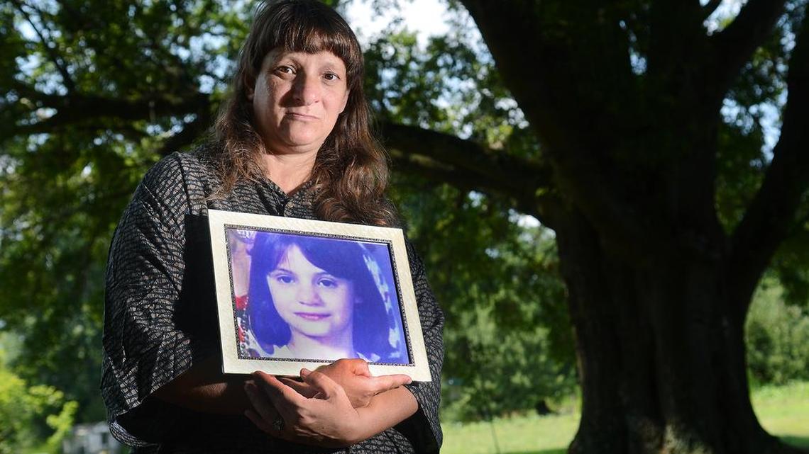 Erica Parsons’ birth mother, Carolyn Parsons, holds a photo of her daughter. Erica’s adoptive parents, Sandy and Casey Parsons, are facing first-degree murder and other charges in Erica’s death.