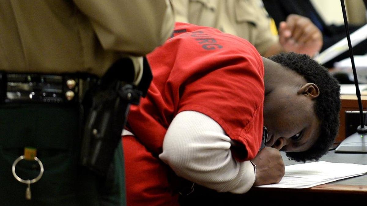 Sabrina Burdea signs papers after arriving in courtroom 5350 at the Mecklenburg Courthouse on Thursday, July 20, 2017. Burdea entered a plea from charges stemming from December 2016. Burdea had attempted a high-speed escape in a stolen car that led to the death of her friend, Marcia Lawton. Thursday was Burdea’s 19th birthday. She will serve 10 months in jail.