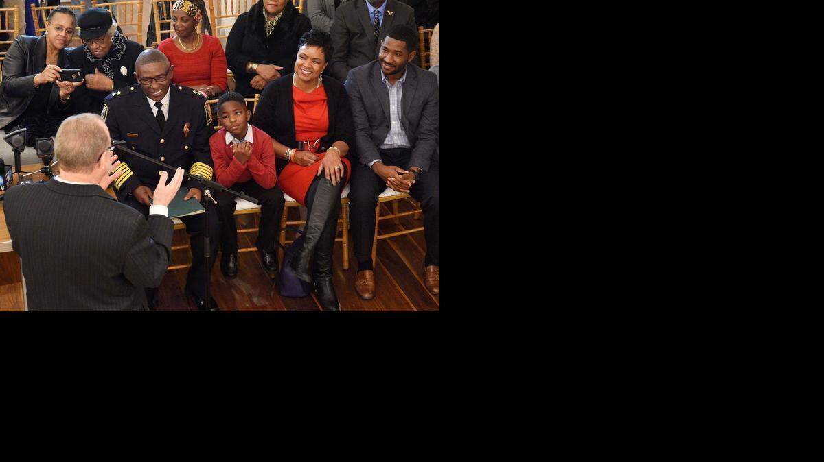 
 Charlotte City Manager Ron Carlee (left) at podium, gives the closing remarks and thanks Police Chief Rodney Monroe (left) seated, and his family (L-R) grandson Jace McCallum 6, wife, Marvette, son, Brandon Monroe. Charlotte-Mecklenburg Police Chief Rodney Monroe received the Order of the Long Leaf Pine award, the highest civilian honor bestowed by the governor of the state. Thereasea Elder, a retired nurse and community leader in Charlotte, nominated Monroe for the award.Today's ceremony was held at Foundation For the Carolinas, Mayor Dan Clodfelter presented Chief Monroe with the award, Feb. 18,2015.
