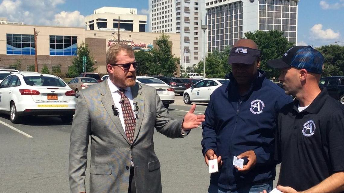 Mecklenburg County Tax Assessor Ken Joyner, left, is shown with two property assessment workers outside his office at Bob Walton Plaza on Stonewall Street on Friday. The workers are wearing assessor’s office shirts and hats that identify them to property owners.
