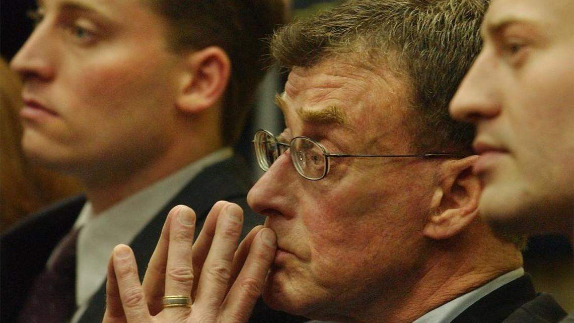 Michael Peterson sits in a Durham courtroom between sons Clayton (left) and Todd in 2002.