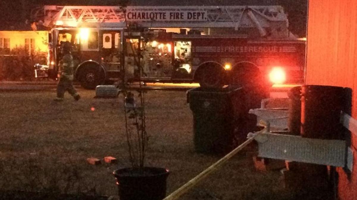 Firefighters respond to the car fire in north Charlotte early Sunday morning.