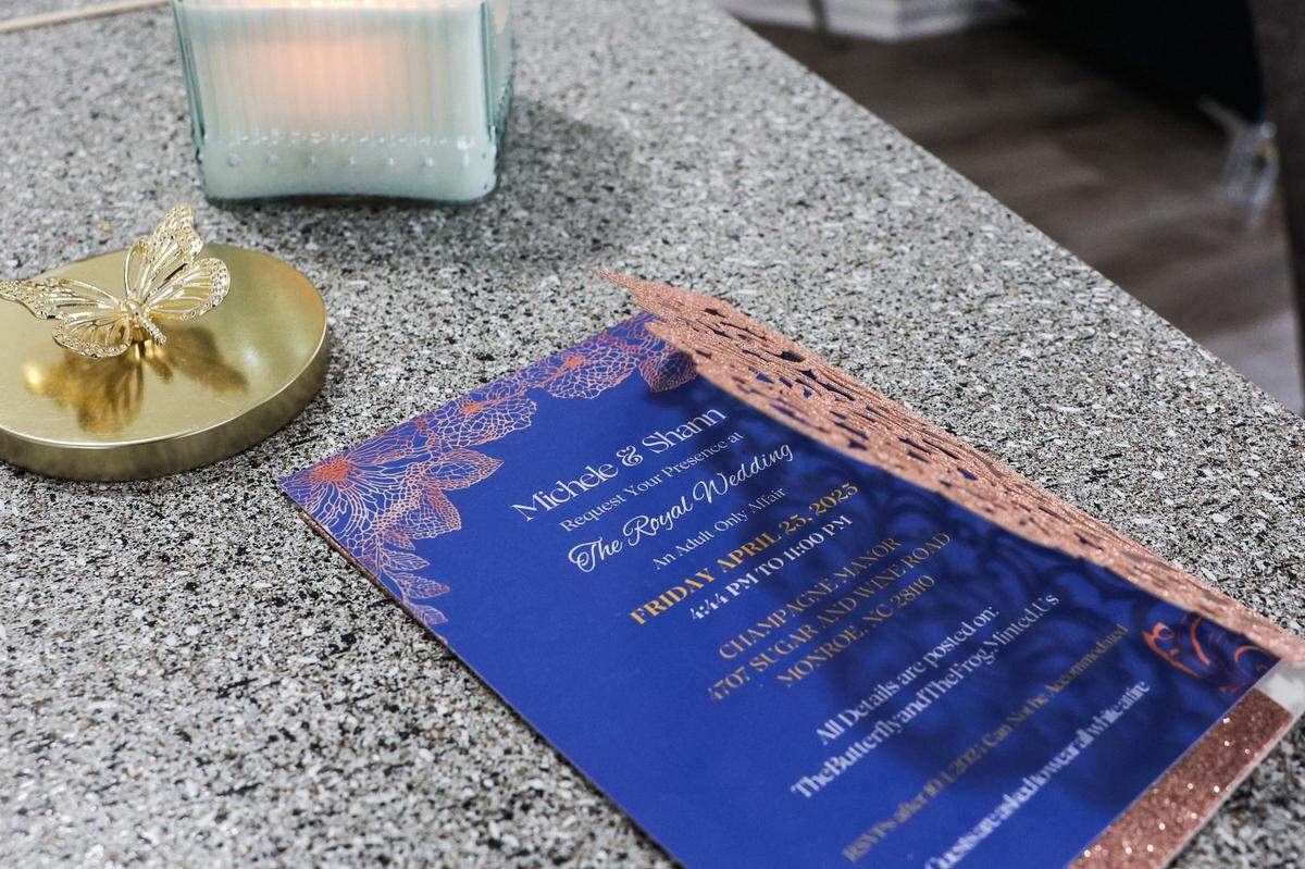 An invitation for Shann Fulton and Michele Edwards’ April 25th wedding sits on the kitchen counter of their Charlotte home. The wedding was canceled after their venue, Champagne Manor in Union County, went into foreclosure.