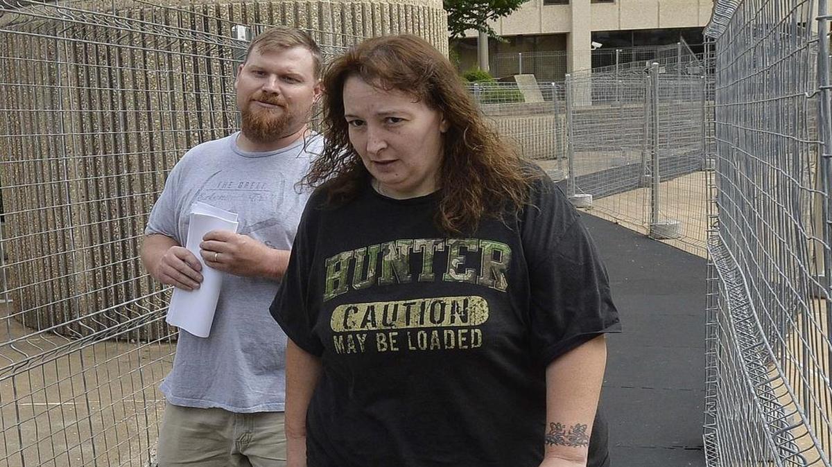Sandy Pasons, left, and his wife Casey Parsons leave the federal courthouse in Winston-Salem after being arrested for financial crimes in 2014.