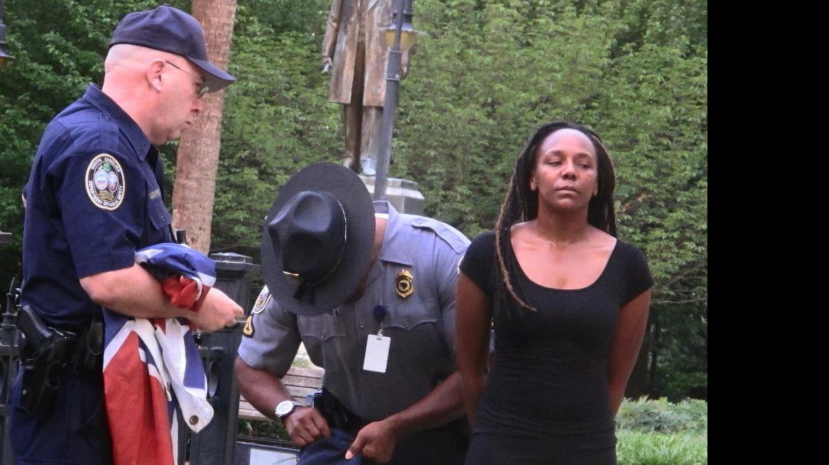 
Bree Newsome of Charlotte, right, is taken into custody after she removed the Confederate battle flag from a monument in front of the SC State House June 27 in Columbia. 
