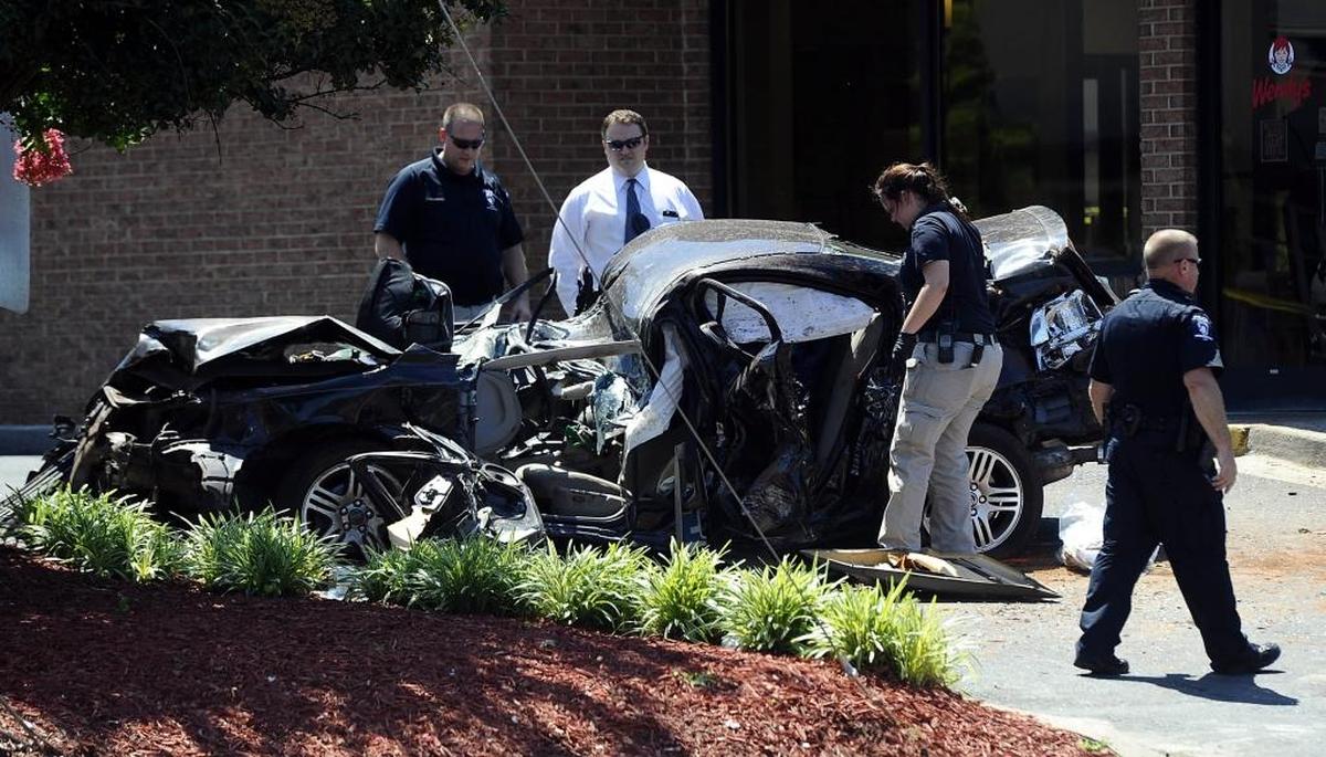 Police investigate the wreckage after a carjacked car went airborne and crashed into a pole while speeding from police on West Sugar Creek Road Thursday morning. The 18-year-old driver, Kahmal Williams Darby, died in the crash. Police said that Darby, armed with a knife, stole a black 2006 Volvo S60 in northwest Charlotte shortly after 5 a.m. Officers spotted the car about four hours later, according to CMPD. That’s when Darby sped off, eventually losing control and smashing into a utility pole. The car ended up in the parking lot of a Wendy’s restaurant.
