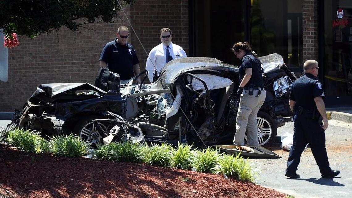 Police investigated the wreckage after a carjacked car went airborne and crashed into a pole while speeding from police on West Sugar Creek Road in Charlotte in 2016.