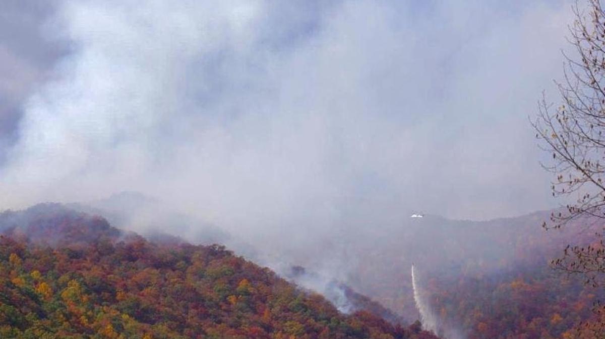 A helicopter dumps water on a wildfire in the Nantahala National Forest during a spate of blazes this autumn.