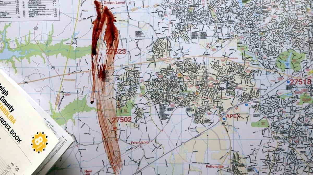 
A streak of blood is seen on a large city map in the newsroom after an unknown person broke into The News & Observer offices early Sunday morning, vandalizing several offices and leaving a bloody trail in the third floor newsroom. 
