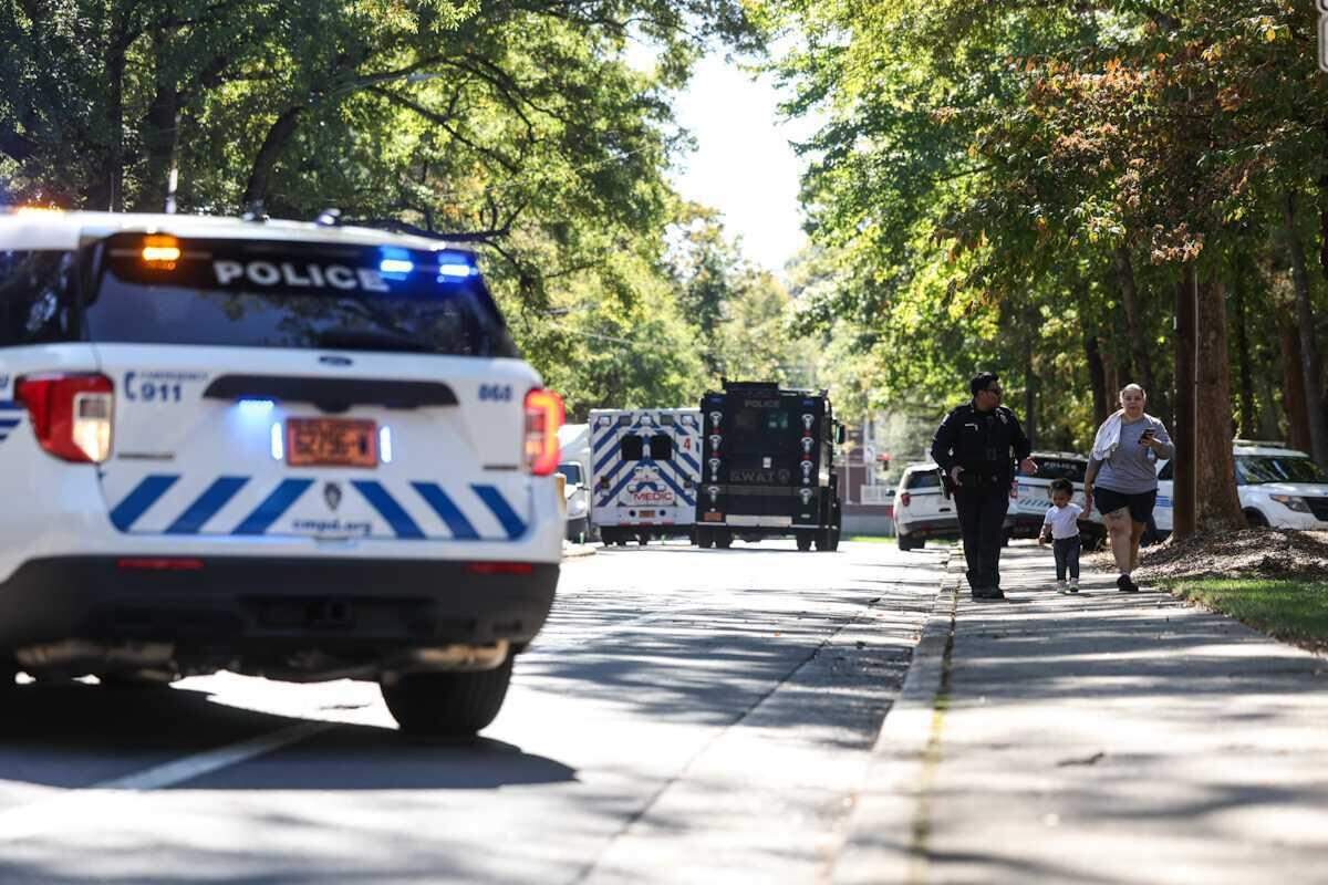 CMPD escorted pedestrians away from the area around an apartment complex in the 1100 block of Woodlawn Road in Charlotte, on Monday, Oct. 21, 2024.
