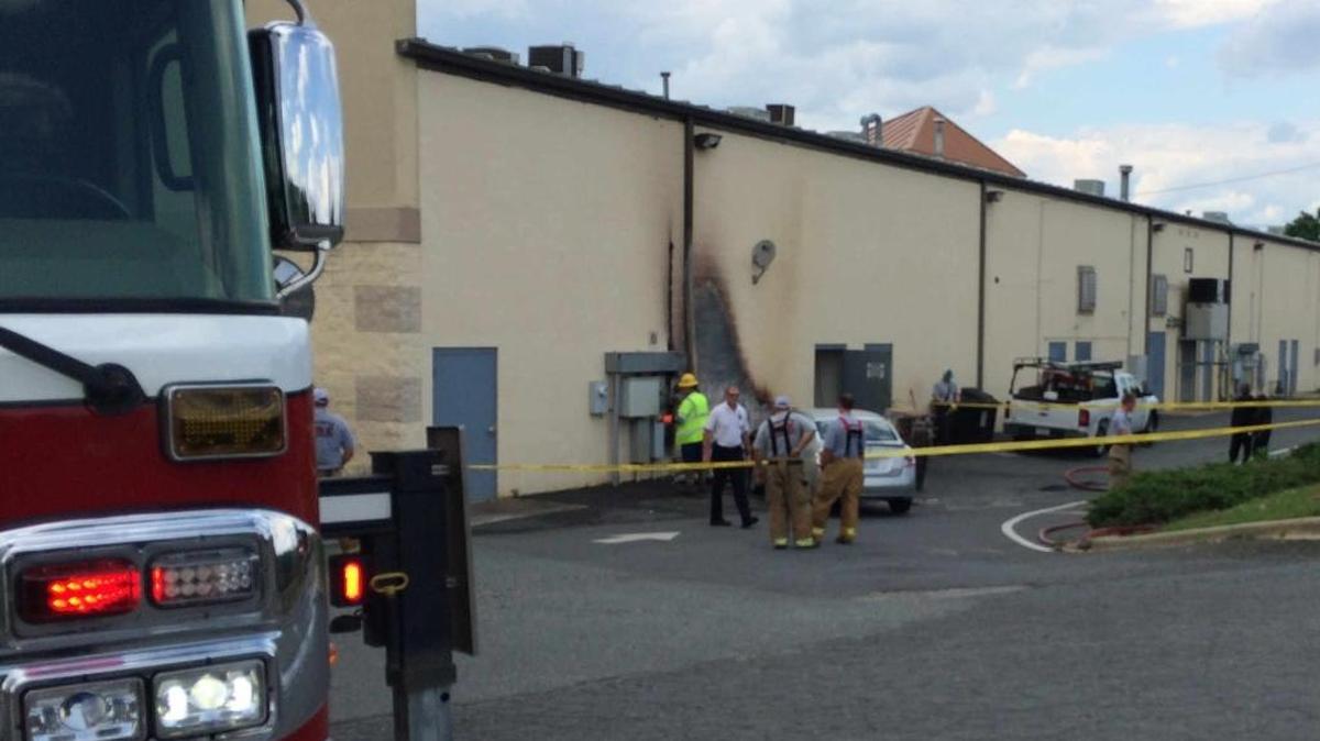 A propane tank ignited after a driver hit the back wall of a shopping center on University City Boulevard.