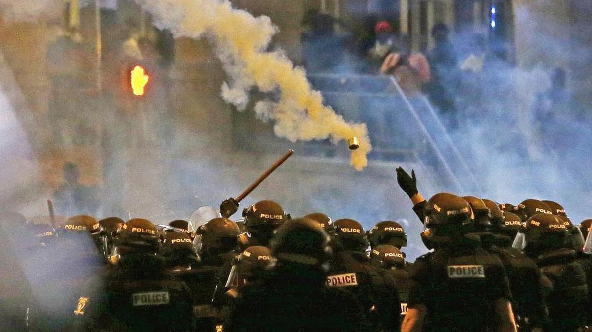 Police fire tear gas as protestors converge in uptown Charlotte after the fatal shooting by a police officer of Keith Lamont Scott.