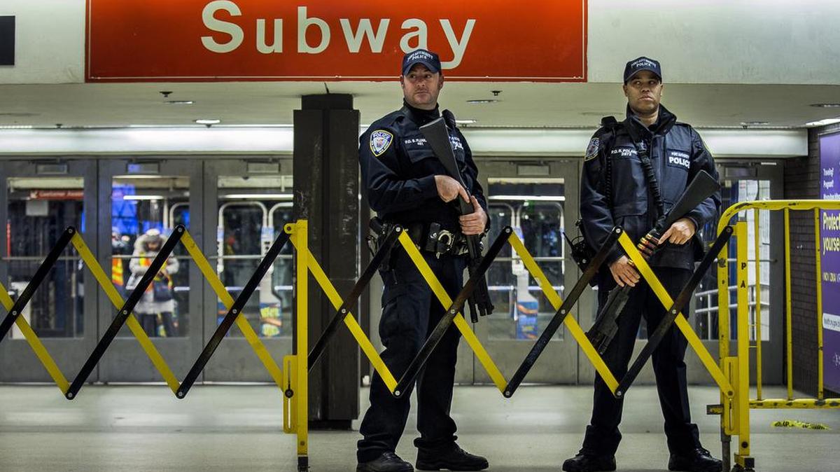 Police stand guard inside the Port Authority Bus Terminal following an explosion near Times Square on Monday. Police said a man with a pipe bomb strapped to his body set off the crude device in a passageway under 42nd Street between Seventh and Eighth Avenues.