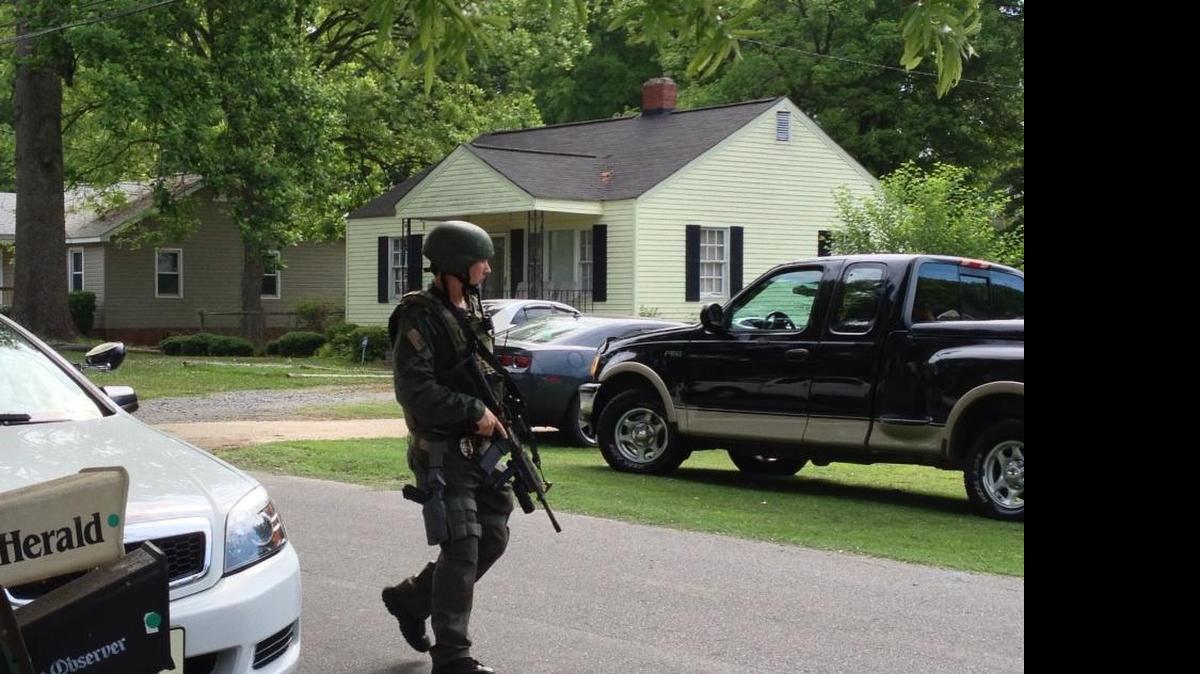 
A SWAT officer arrives to the scene of Horseman Drive, where a suspect has barricaded himself in his home. 
